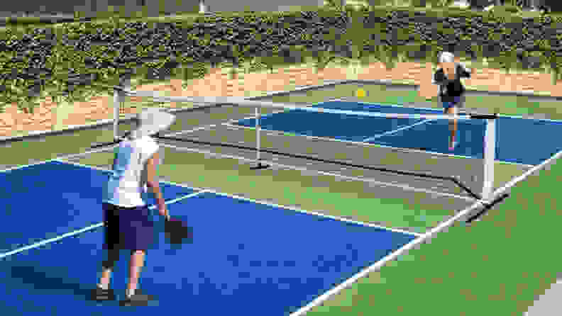 Two people on pickleball court playing a set