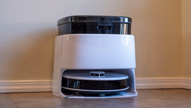 A round robot vacuum in its docking station