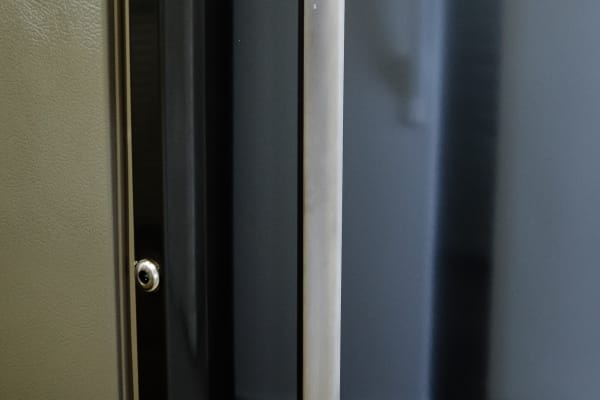 The chrome handle acts as an interesting visual contrast to the Frigidaire FFU27F2PT's slate door.