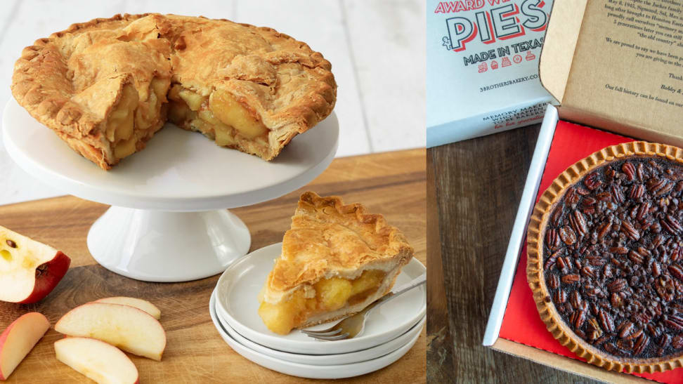 An apple pie with a slice cut from it sits on a cake stand next to the slice on a plate; next to it is a pecan pie in a delivery box.