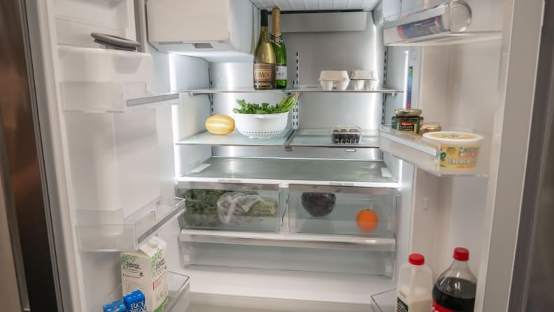 Inside shelving on the Bosch B36FD50SNS French-door Refrigerator with food on them.