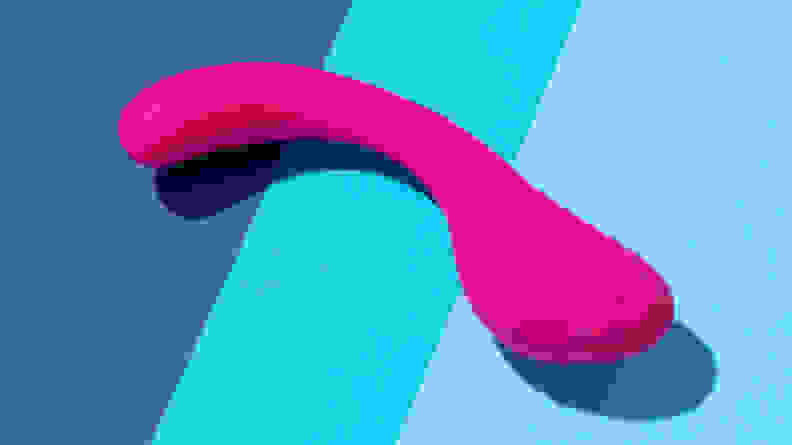 The pink Lovehoney Power Play G-spot vibrator on top of 3-tone blue surface.