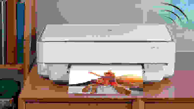 An image of a printer on a dresser.