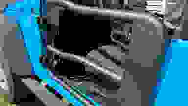 Angled outside view of a Rugged Ridge Fortis Tube Door installed on the driver's side of a light blue Jeep.