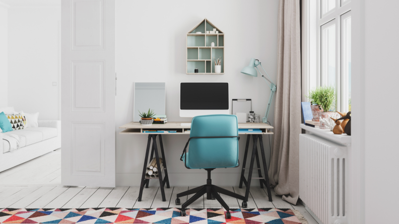 Modern office space with computer monitor on top of desk.