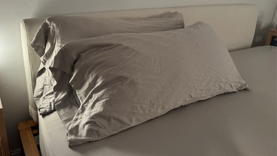 A set of gray cozy earth bed sheets on a bed with two pillows in the Cozy Earth pillowcases.