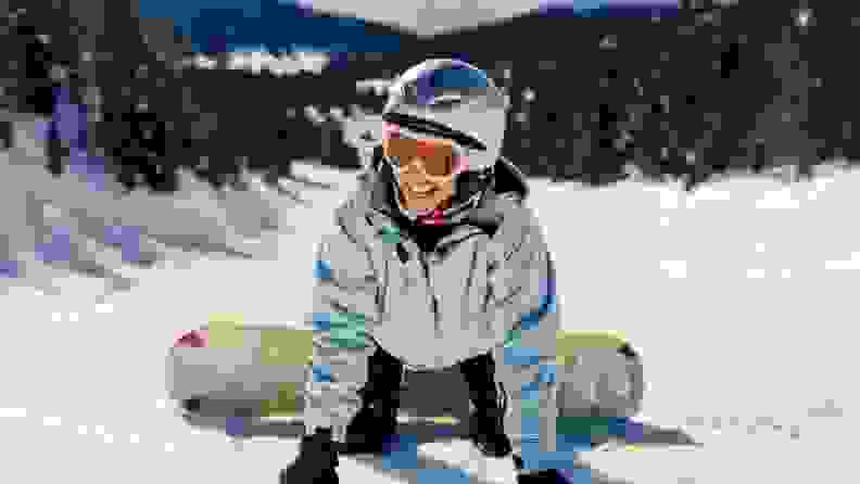 Person having fun while snowboarding outdoors.