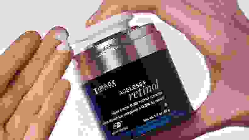 Model pumps IMAGE Skincare Retinol onto fingertips