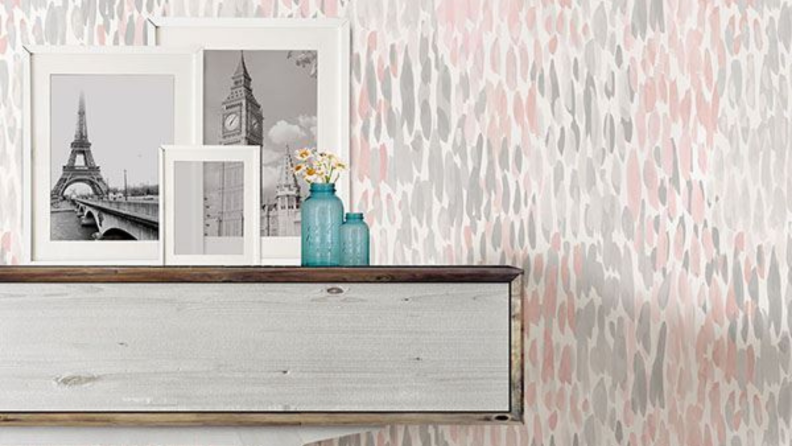 pink and gray wallpaper behind a table