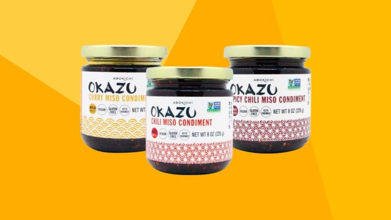 Three jars of miso condiments against a yellow background.