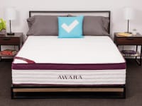 The Awara Premier Natural Hybrid Mattress in a bedroom between two bedside tables.
