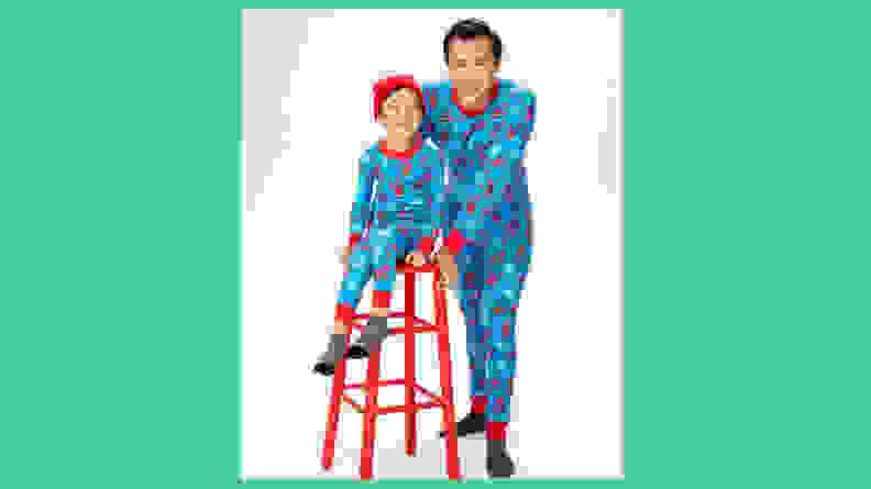 A father and son wearing the Hanna Andersson Spider-Man holiday matching family pajamas.