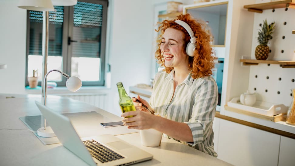 Woman drinking beer on video call