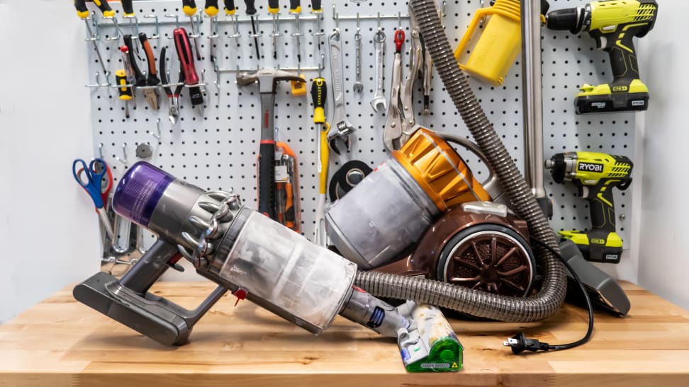 Various types of corded and cordless vacuums sit on a tabletop