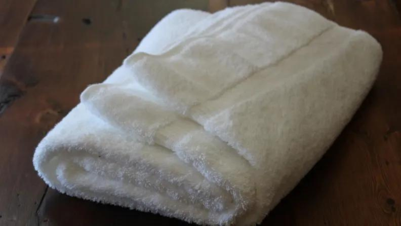 A white towel sitting on a table.