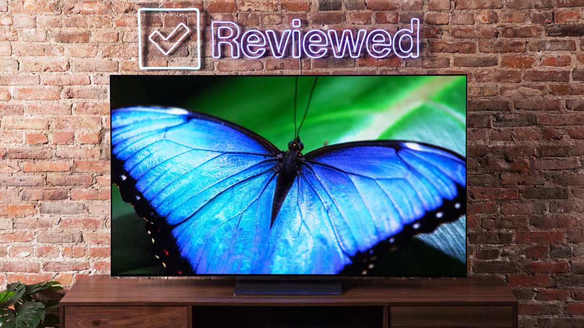 An LG G2 OLED TV with a blue butterfly displayed on its screen.