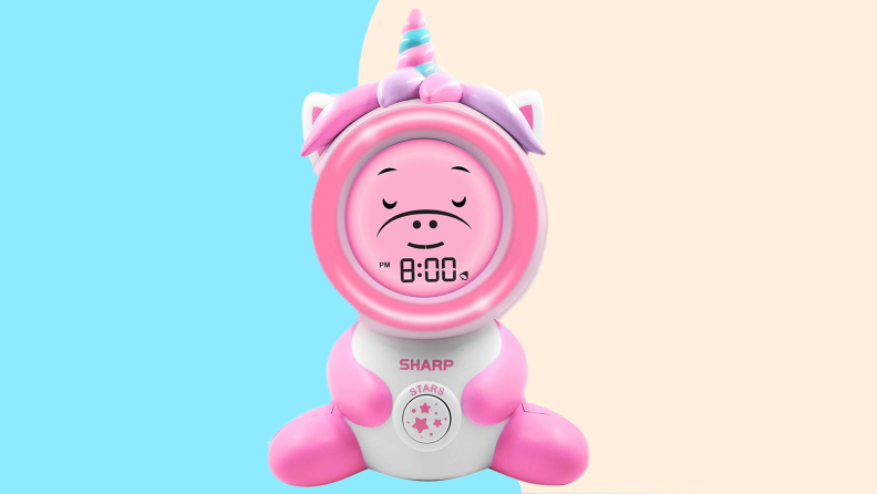 Pink unicorn shaped alarm clock with time display.