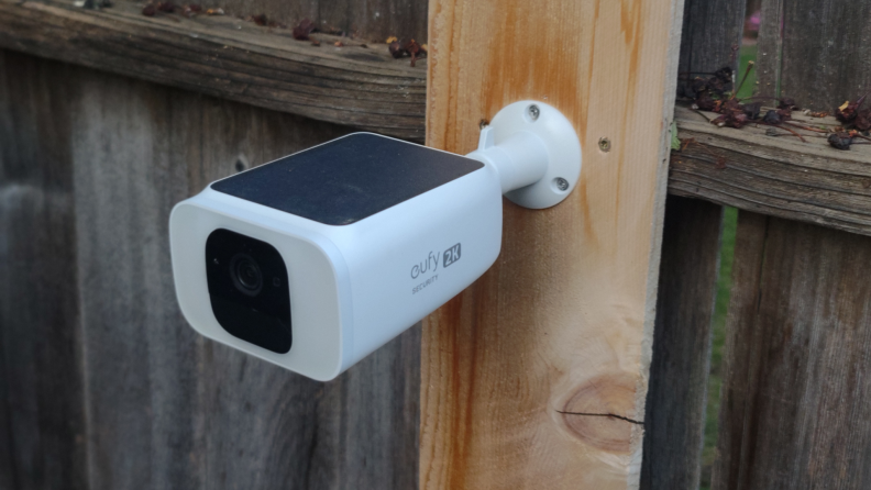Close up of a Eufy security camera with a solar battery.