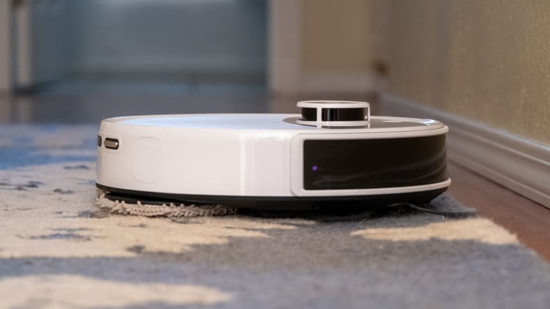 Side view of a robot vacuum on a floor