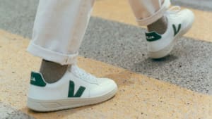 A model walking down the street in Veja sneakers.