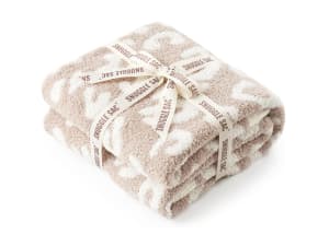 Three throw blankets placed on a couch