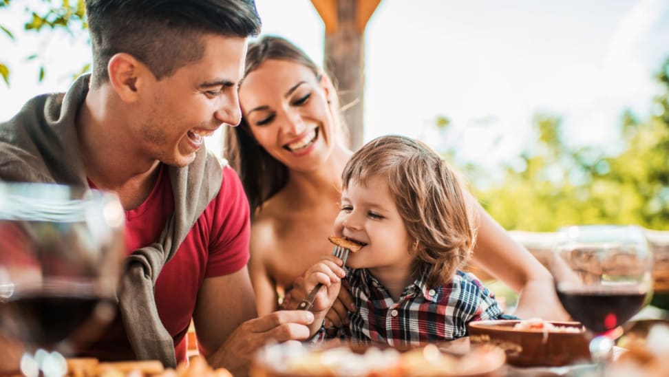 Family smiling of three out to dinner.