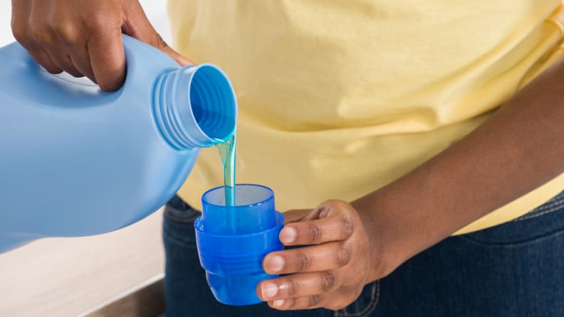 Pouring laundry detergent