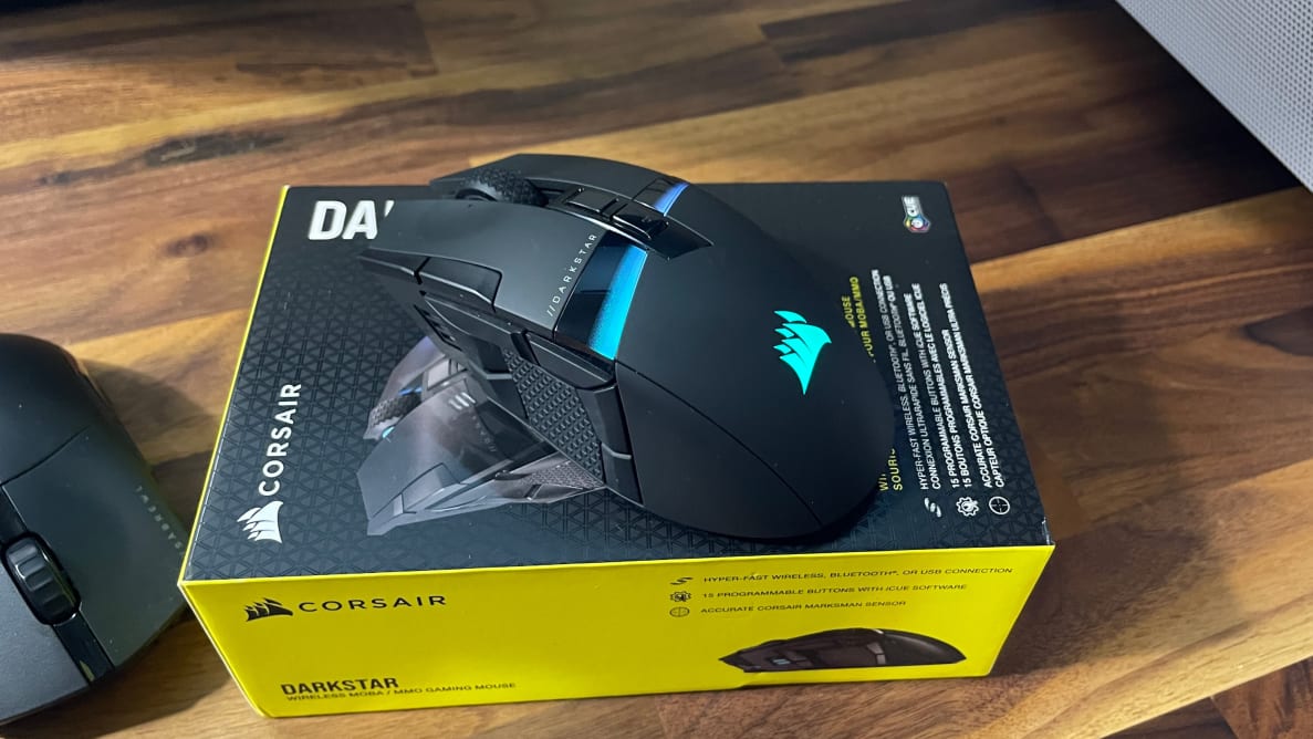 The Corsair Darkstar Wireless mouse on top of a yellow box.