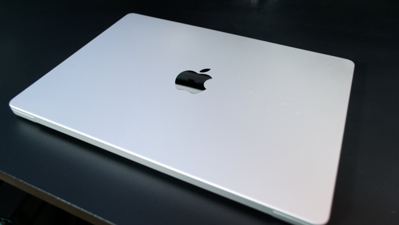 The MacBook Pro 14 M3 closed on a black table.