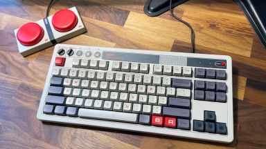 The 8Bitdo Retro Mechanical Keyboard on a wood desk.