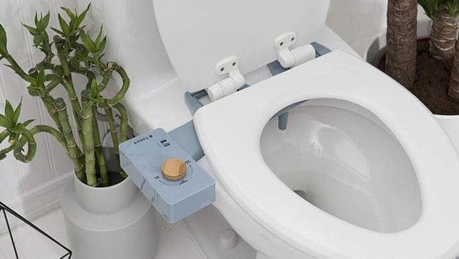 White toilet with a blue bidet attached