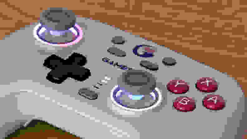 Close-up of a controller, the Gamesir Nova, with RGB rings around the joysticks.