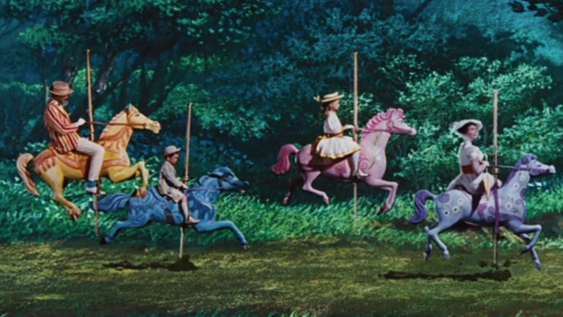A still from 'Mary Poppins' featuring Mary, Bert, and the Banks children on carousel horses.