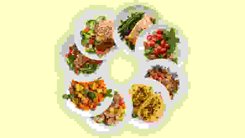 A variety of prepped meals in organized in circular form on a yellow background