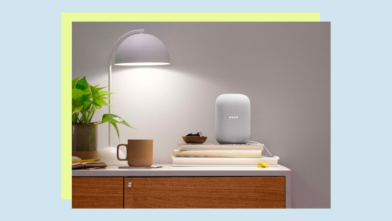 A smart speaker sits on an end table inside a home.