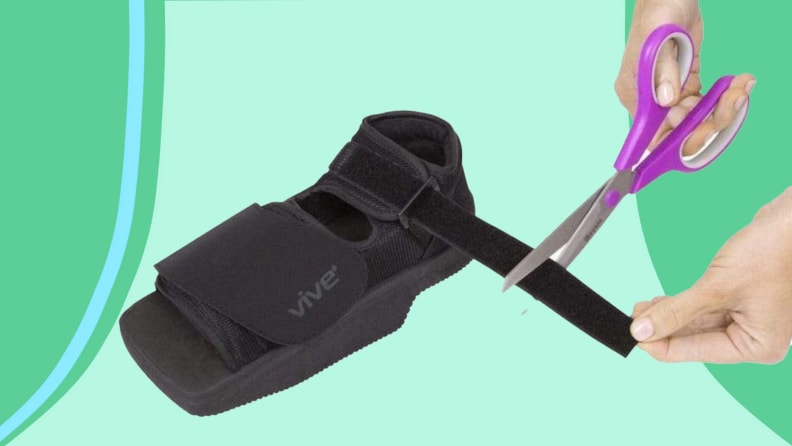 Person using scissors to cut velcro on heel wedge post-operation shoe.