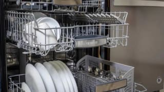 A Bosch dishwasher with its middle and upper racks open.