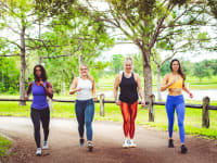 Four women walking in a park