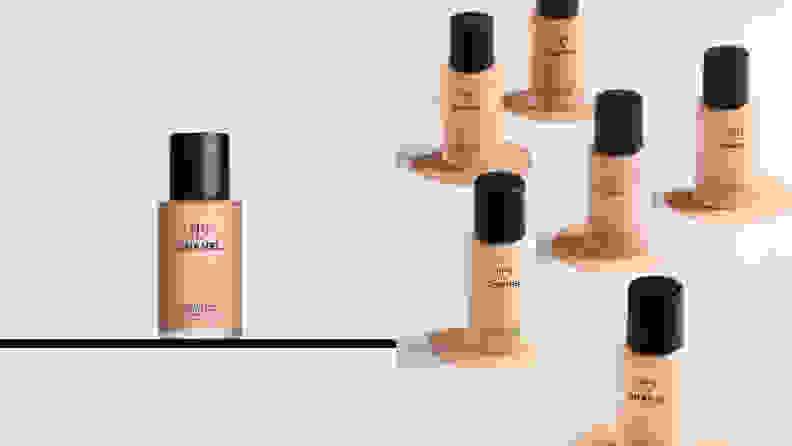 On the left: A single bottle of foundation on a shelf. On the right: Several foundations in light shade colors on a gray background.