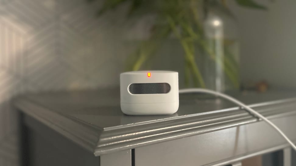 The Amazon Smart Indoor Air Quality Monitor sits atop a gray shelf and monitors the air.