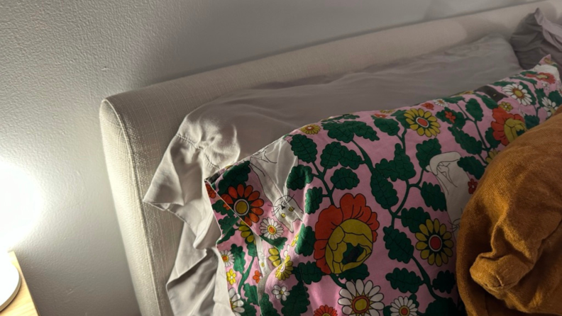 A wrinkled Cozy Earth pillowcase sitting behind a decorative pillowcase.