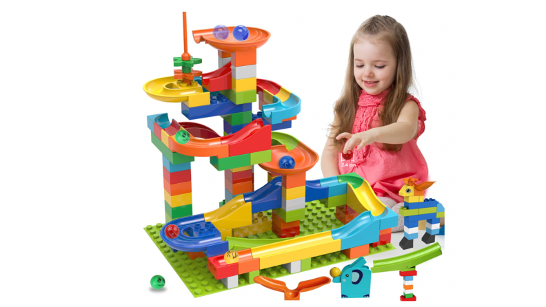 A little girl with a buildable marble run.