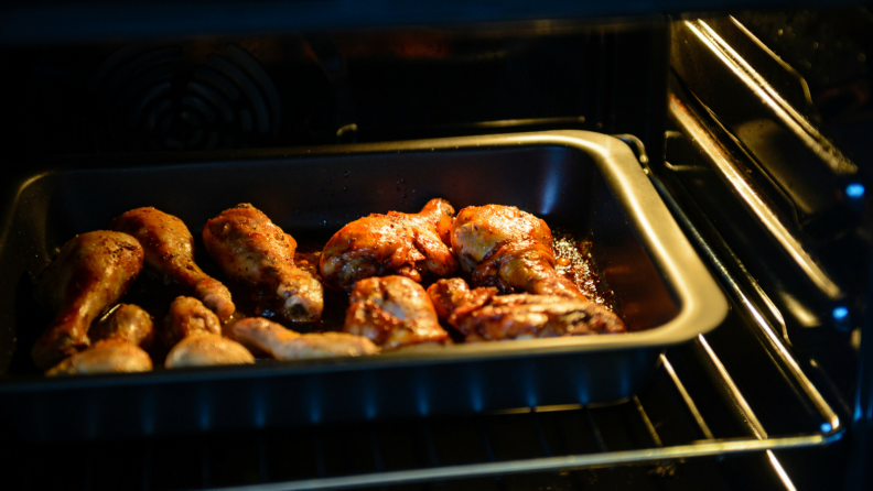 Chicken wings baking in an oven.