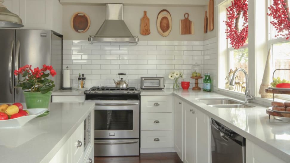 Red accents look beautiful in a white kitchen