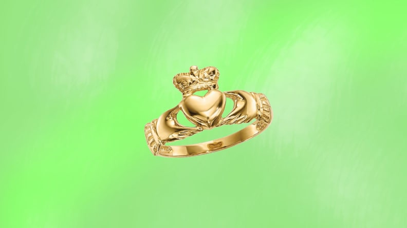 A gold ring in front of a green background.