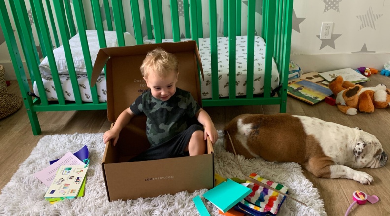 A child plays inside of a box
