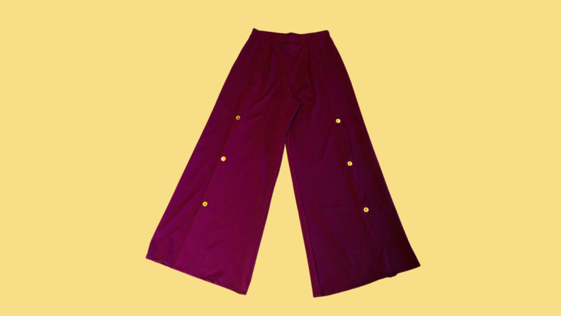 Maroon wide-leg pants with gold buttons on the legs.