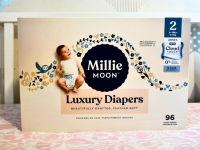 Millie Moon luxury diapers box inside a crib.