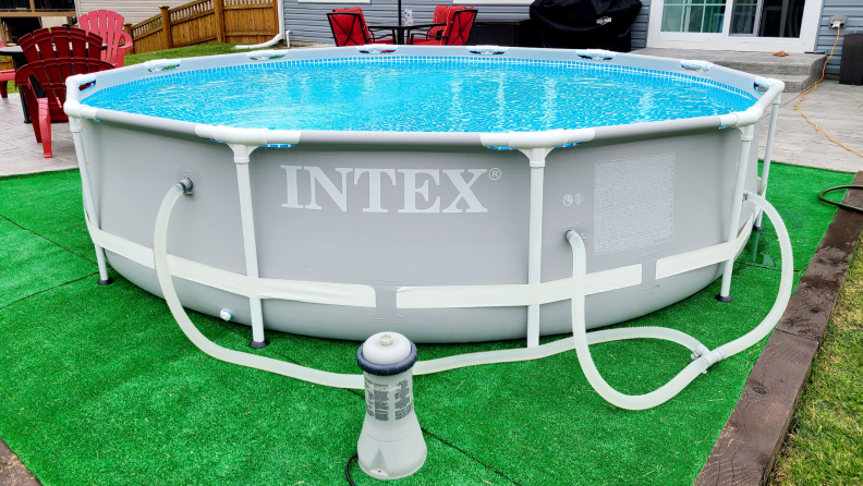 A metal frame above-ground pool in a backyard.