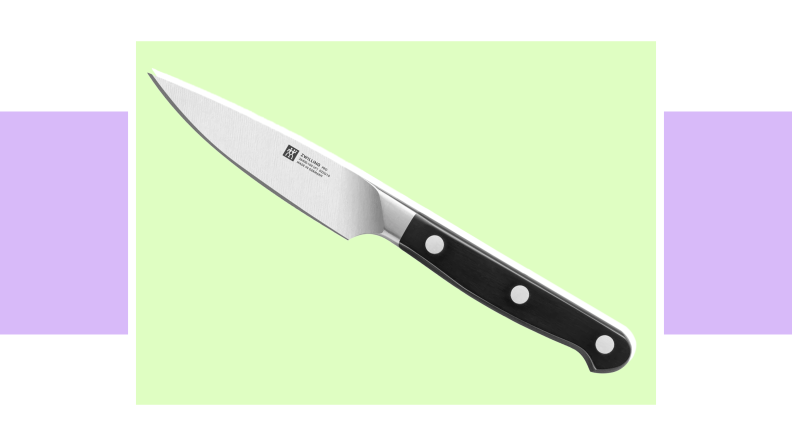 An image of a small paring knife with a black handle.